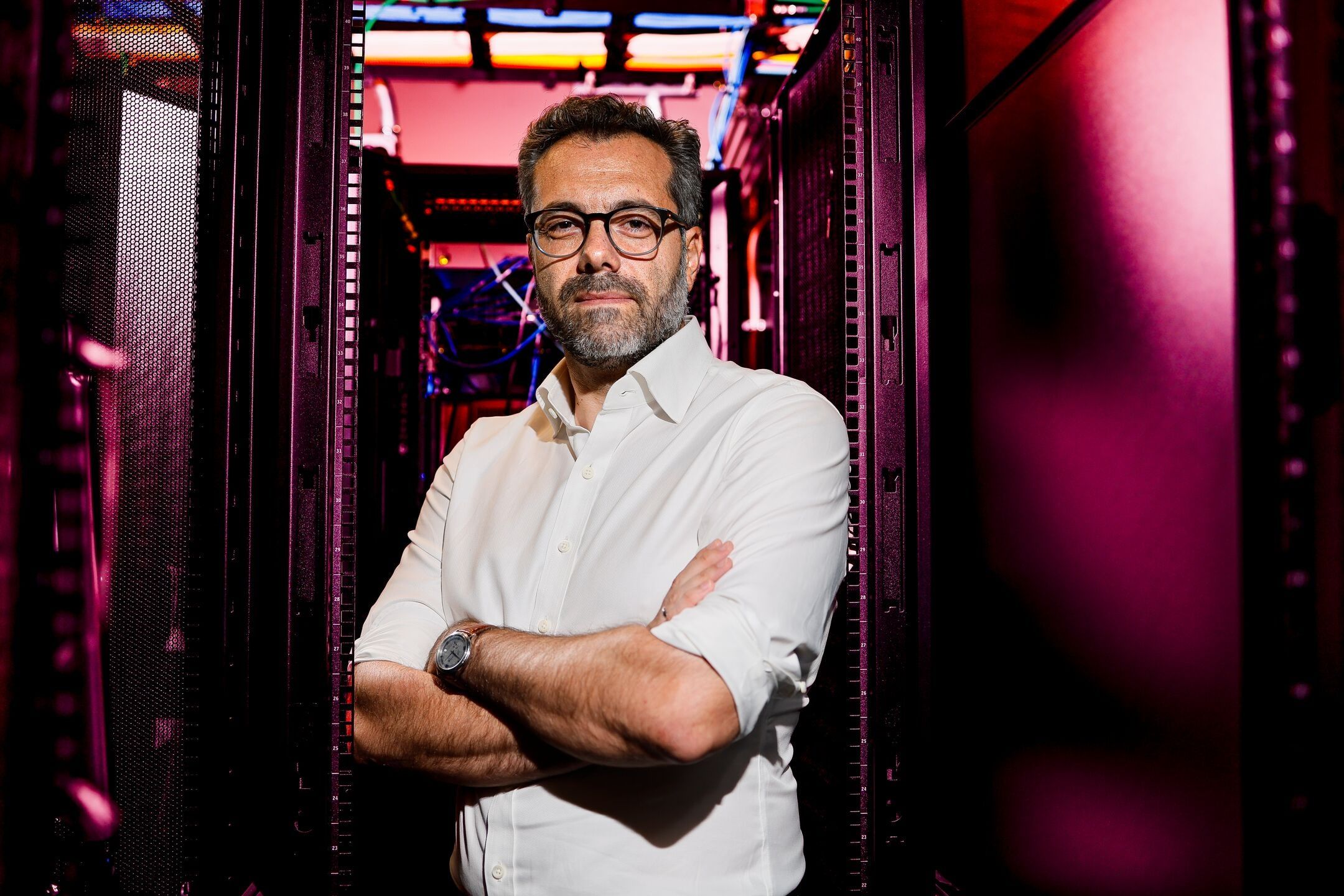 Theodoros Zanos, head of the Division of Health AI, standing in a hospital data center corridor