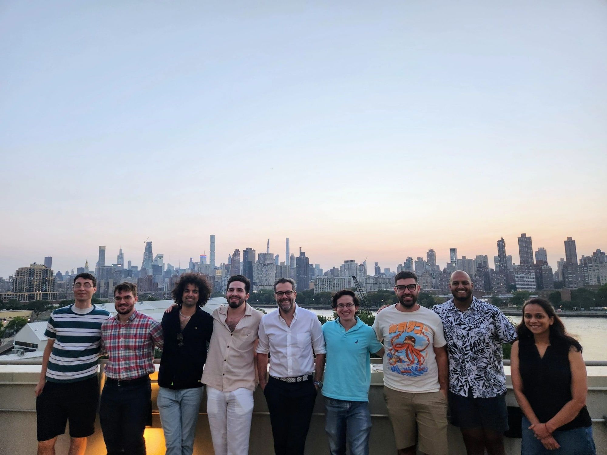 The division on a rooftop at sunset with the New York City skyline, 2024